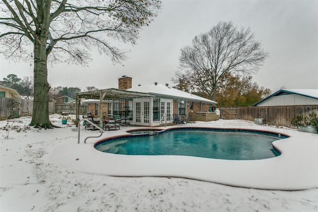 view of swimming pool with an in ground hot tub and french doors