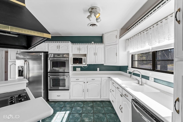 kitchen with white cabinetry, sink, stainless steel appliances, and island exhaust hood