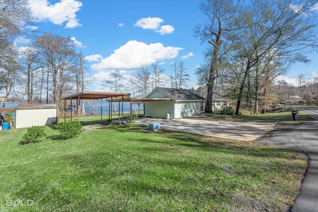 exterior space with a carport, a front yard, and a storage shed