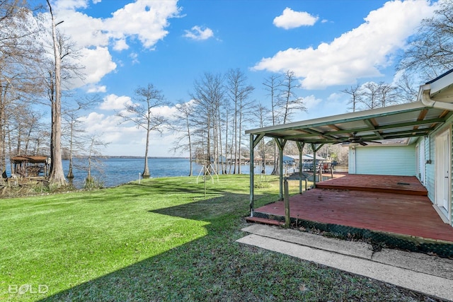 view of yard with a deck with water view