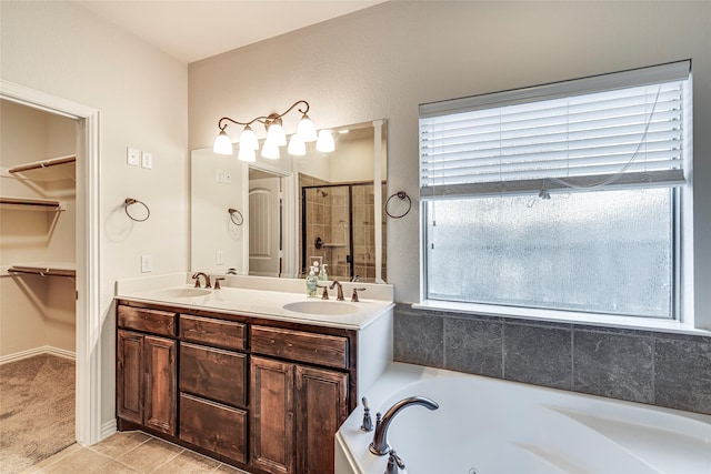 bathroom featuring vanity and independent shower and bath