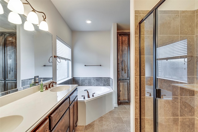 bathroom featuring independent shower and bath, vanity, and tile patterned floors