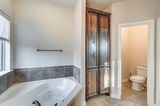 bathroom featuring a bath, tile patterned floors, and toilet