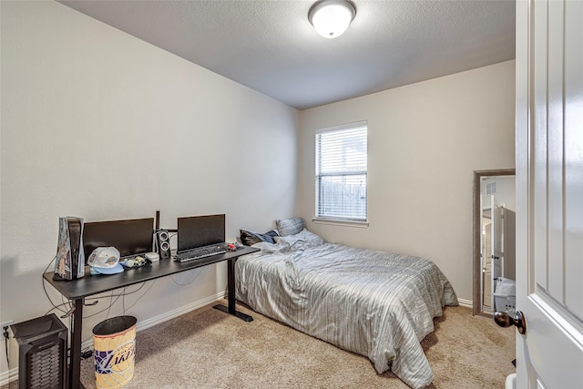 carpeted bedroom featuring a textured ceiling