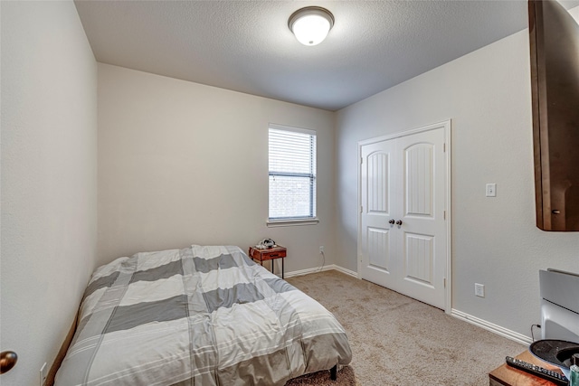 carpeted bedroom featuring a textured ceiling