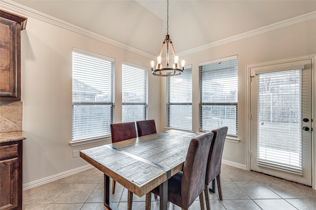 tiled dining area with lofted ceiling, crown molding, and a chandelier