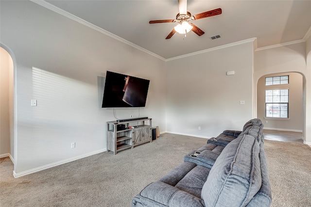 carpeted living room featuring ornamental molding and ceiling fan