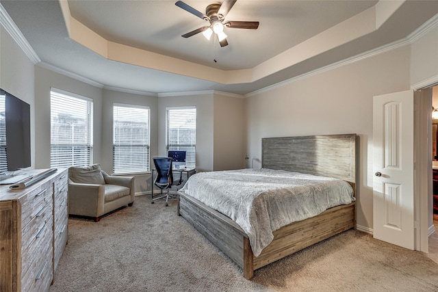 carpeted bedroom with crown molding, ceiling fan, and a tray ceiling