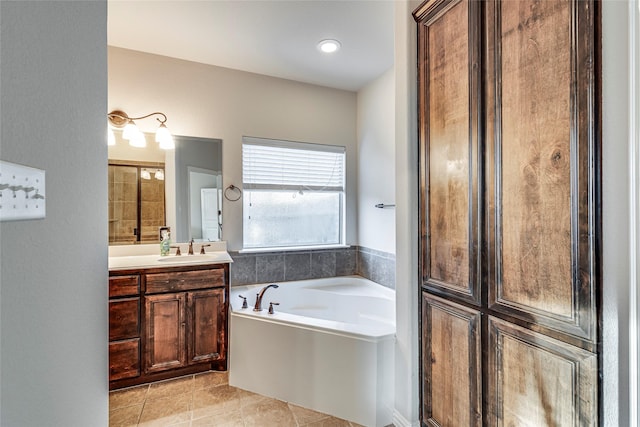 bathroom featuring tile patterned flooring, vanity, and a tub