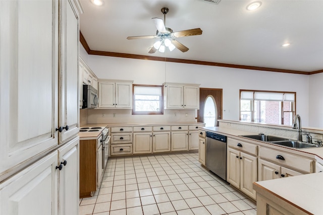 kitchen featuring sink, ceiling fan, appliances with stainless steel finishes, ornamental molding, and light tile patterned flooring