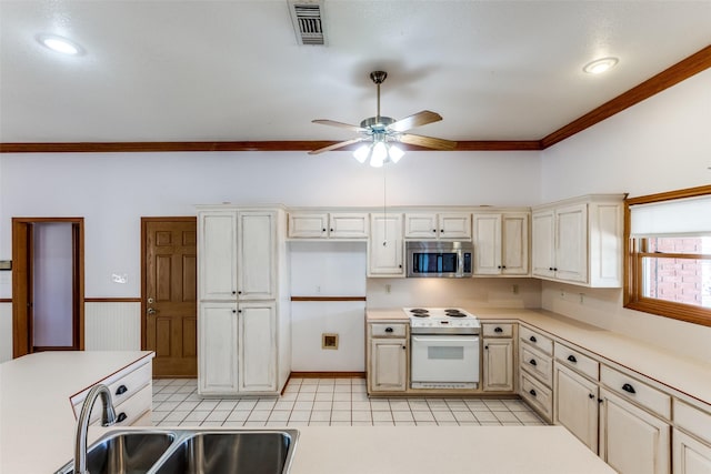 kitchen featuring white range with electric cooktop, sink, ornamental molding, ceiling fan, and cream cabinets