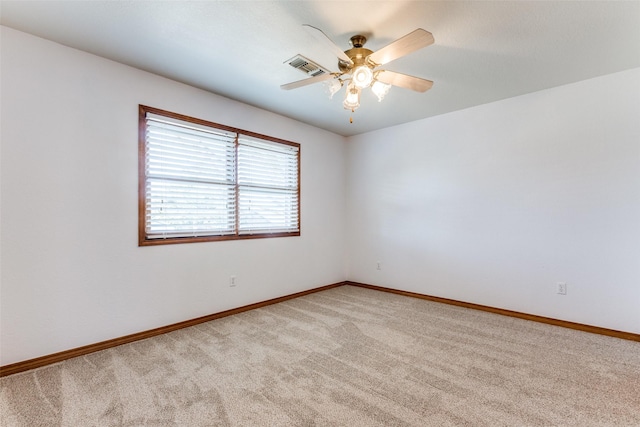 unfurnished room featuring light carpet and ceiling fan