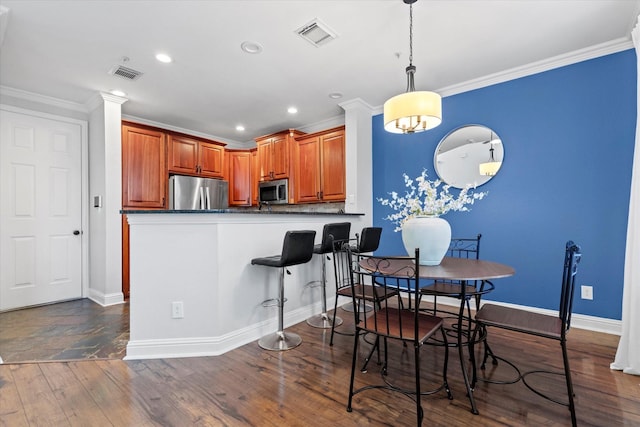 dining area featuring dark hardwood / wood-style floors and ornamental molding