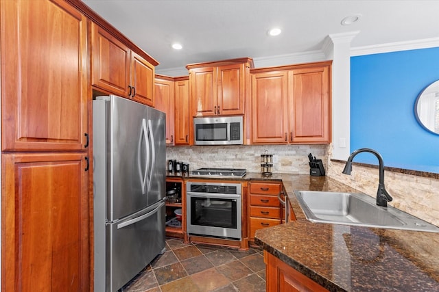 kitchen with decorative backsplash, appliances with stainless steel finishes, crown molding, sink, and dark stone countertops