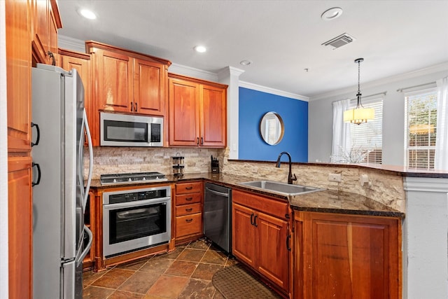 kitchen featuring sink, hanging light fixtures, ornamental molding, kitchen peninsula, and stainless steel appliances