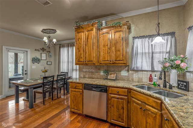 kitchen with sink, stainless steel dishwasher, dark hardwood / wood-style floors, a chandelier, and decorative light fixtures