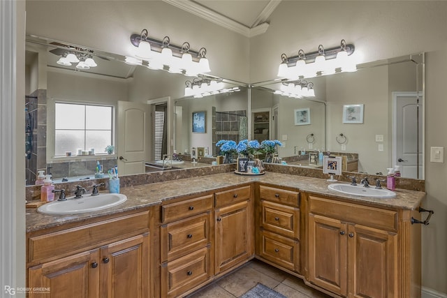 bathroom with tile patterned flooring, vanity, and crown molding