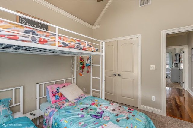 bedroom featuring lofted ceiling, carpet floors, and crown molding