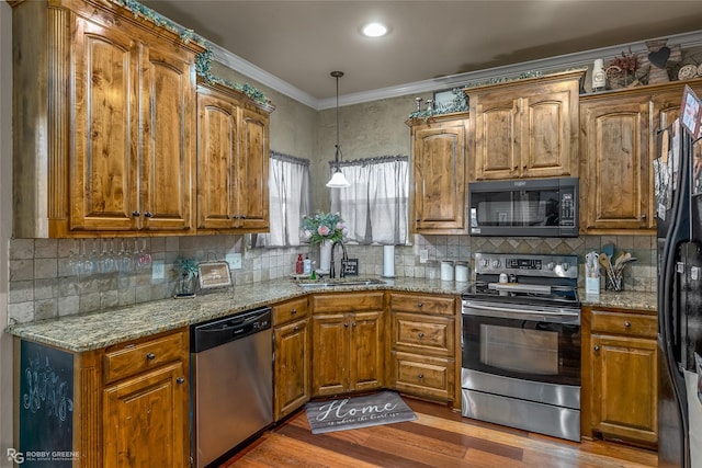 kitchen with black appliances, light stone countertops, sink, and hardwood / wood-style floors