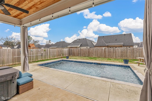 view of swimming pool featuring ceiling fan, a patio, and a hot tub