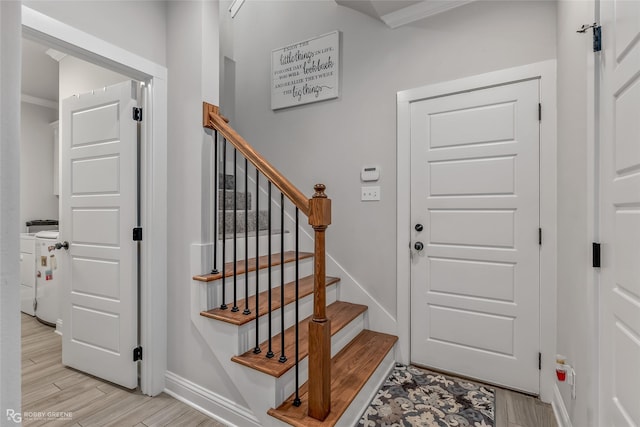 entryway featuring washer / clothes dryer and light hardwood / wood-style flooring