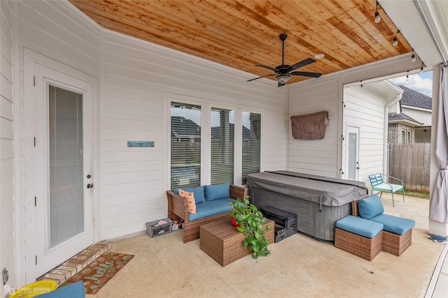 view of patio with outdoor lounge area, ceiling fan, and a hot tub