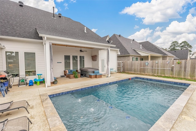 view of swimming pool featuring ceiling fan, a patio area, and a hot tub