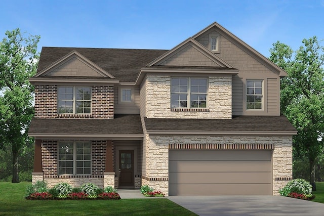 view of front of home featuring a front yard and a garage