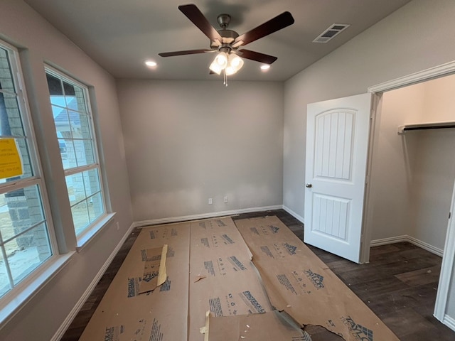 unfurnished bedroom with ceiling fan and dark hardwood / wood-style flooring