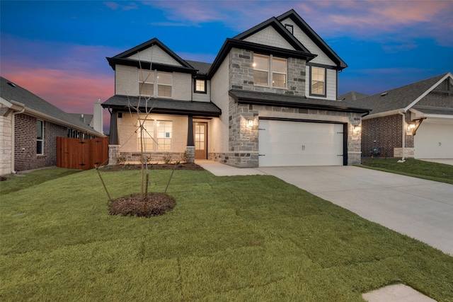 view of front of home with a garage, fence, stone siding, a yard, and concrete driveway