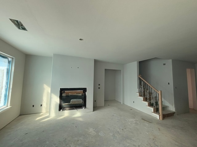 unfurnished living room with a fireplace and plenty of natural light