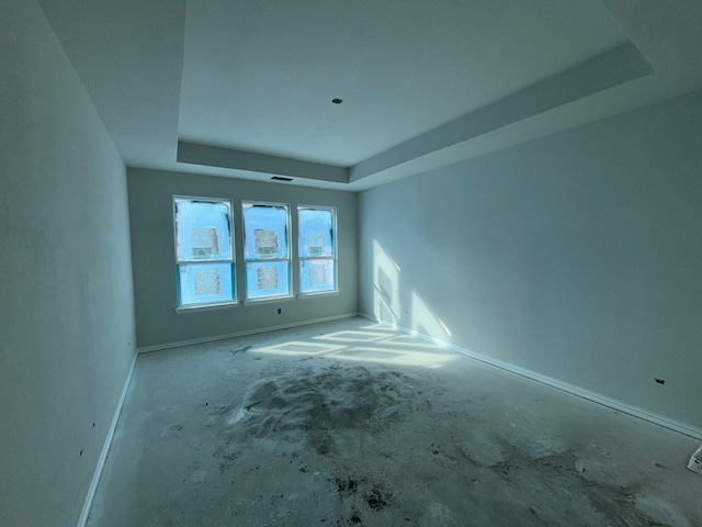 unfurnished room with a raised ceiling