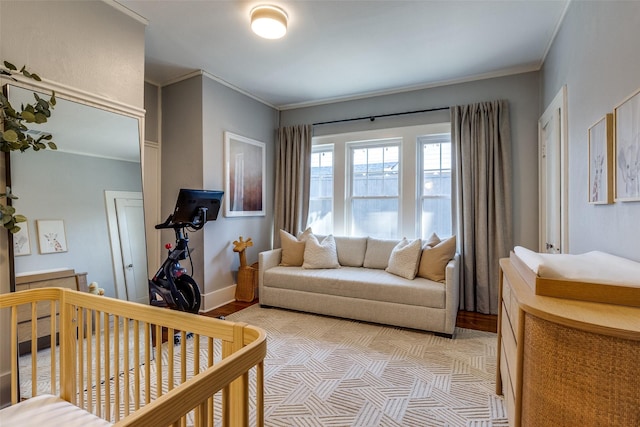 bedroom with crown molding and a crib