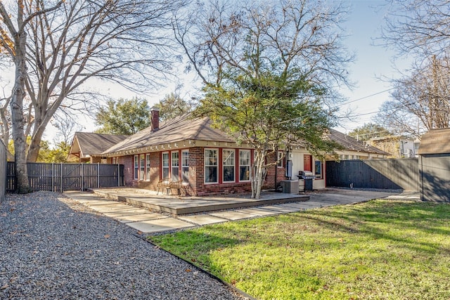 back of house featuring a yard and a patio