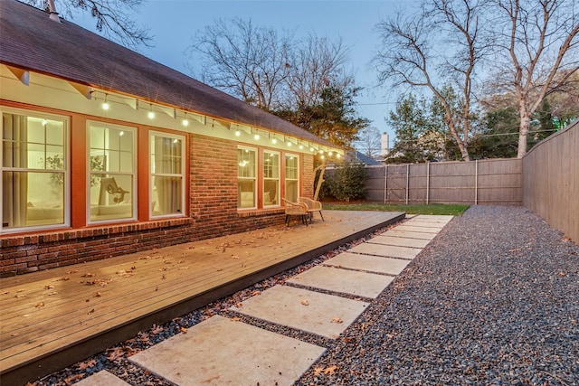 yard at dusk with a patio and a wooden deck