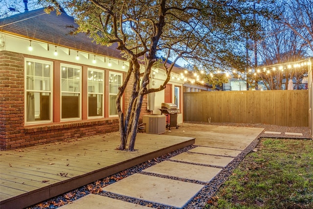 view of side of property featuring central AC and a deck