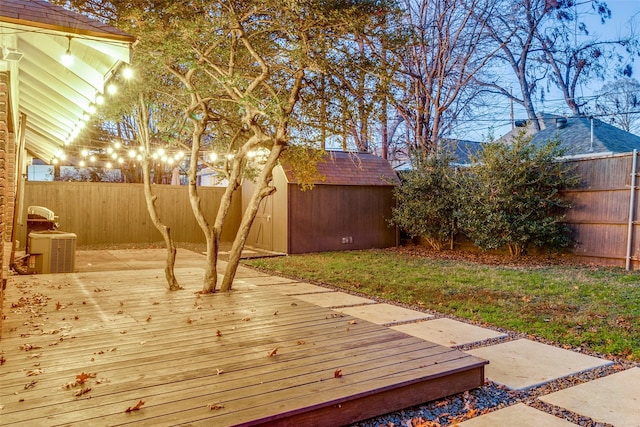 deck featuring central AC and a storage unit