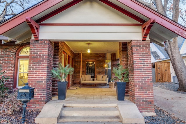 view of exterior entry with covered porch