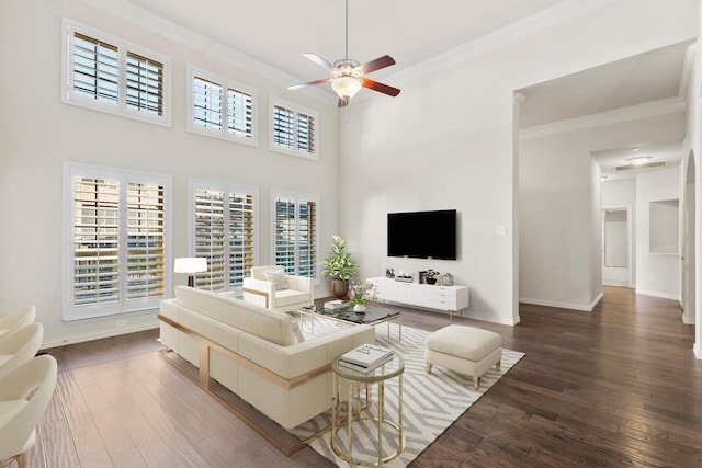 living room with plenty of natural light, ceiling fan, and dark wood-type flooring