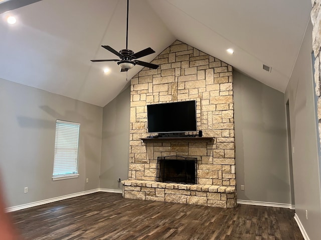 unfurnished living room featuring a stone fireplace, high vaulted ceiling, dark hardwood / wood-style floors, and ceiling fan