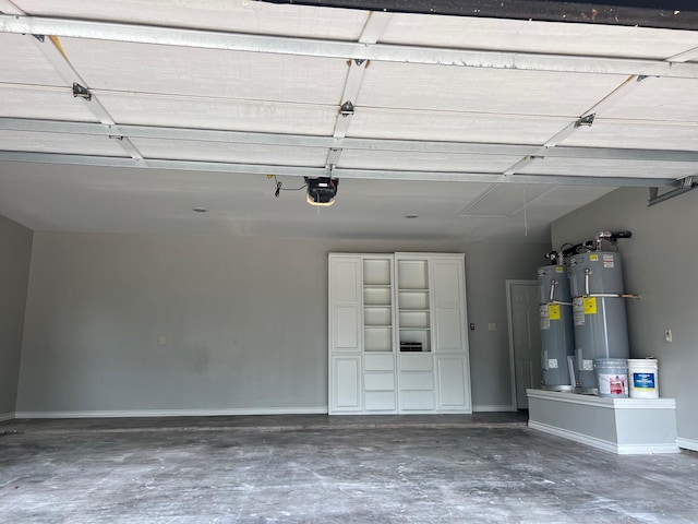 garage with a garage door opener and electric water heater