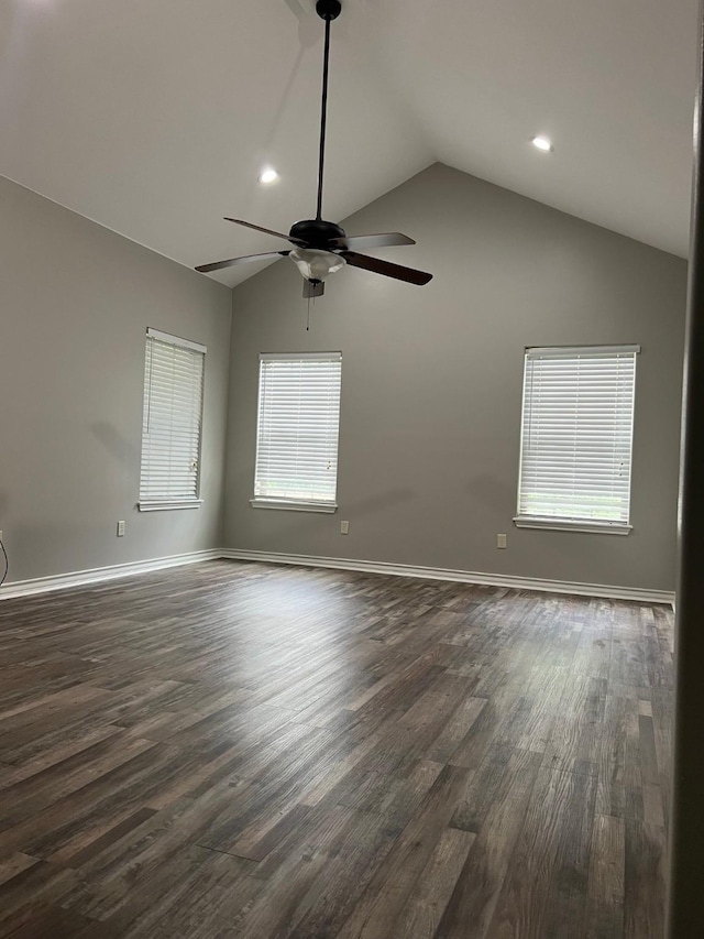 spare room featuring ceiling fan, lofted ceiling, and dark hardwood / wood-style flooring