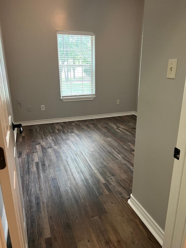 empty room featuring dark hardwood / wood-style flooring