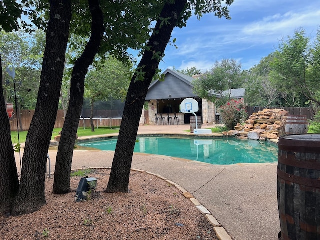 view of pool with an outdoor bar