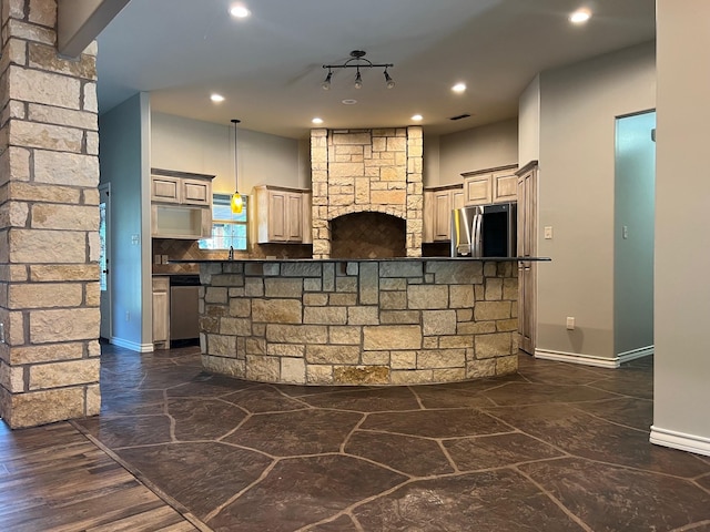 bar with stainless steel appliances and hanging light fixtures