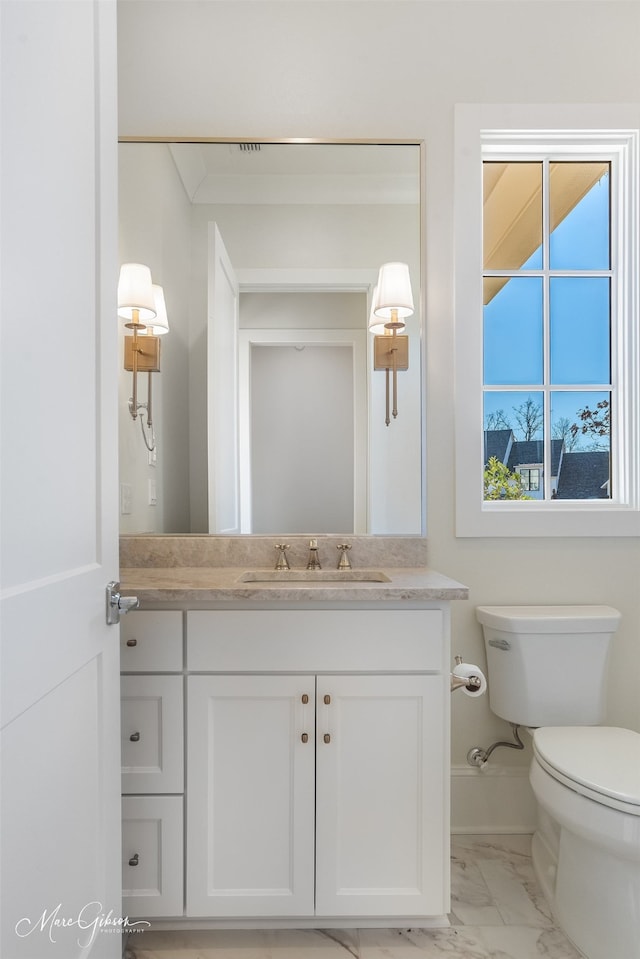 bathroom featuring vanity and toilet