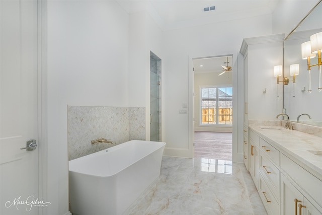 bathroom with vanity, a tub, and ornamental molding