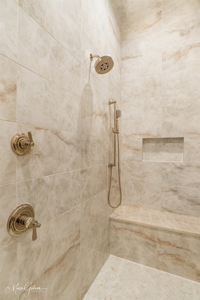 bathroom with tiled shower