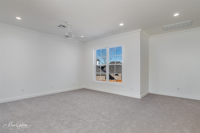 empty room featuring crown molding, light carpet, and ceiling fan