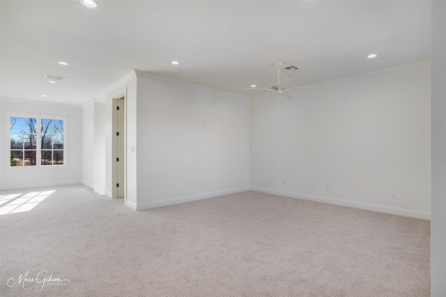 carpeted empty room with crown molding and ceiling fan